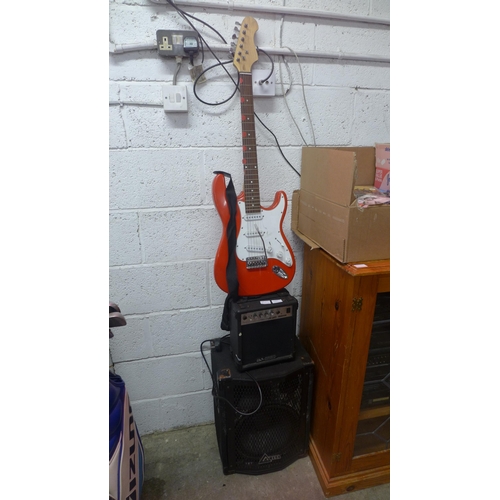 2207 - A red electric guitar, Delta speaker and an Acoustic Solutions amp