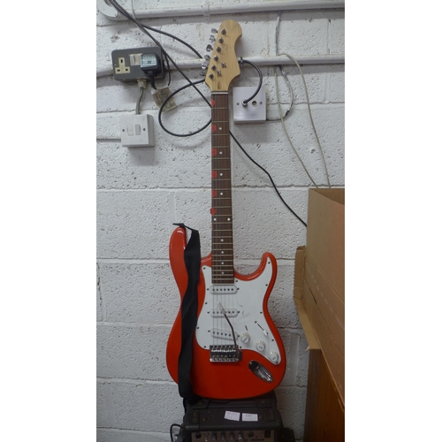 2207 - A red electric guitar, Delta speaker and an Acoustic Solutions amp