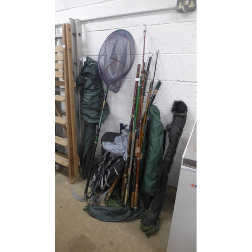 2215 - A job lot of fishing equipment; rods, nets, fishing chair, bivee, etc.