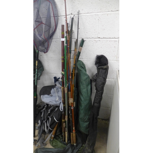 2215 - A job lot of fishing equipment; rods, nets, fishing chair, bivee, etc.