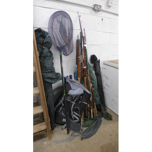 2215 - A job lot of fishing equipment; rods, nets, fishing chair, bivee, etc.