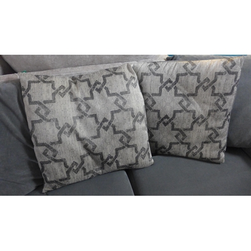 1567 - A mid grey upholstered scatter back three seater sofa with patterned cushions, used