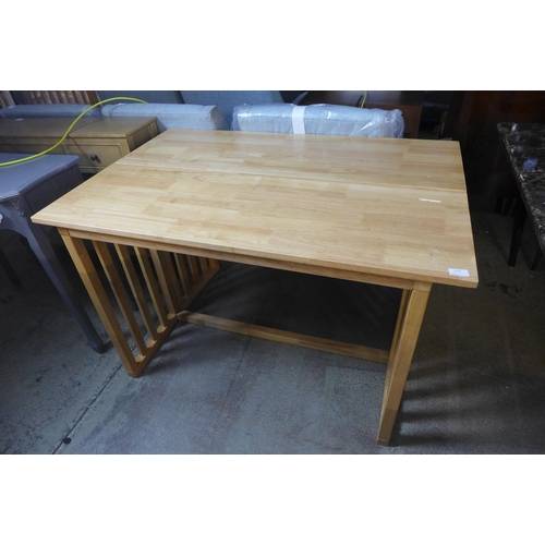 1576 - A beech folding dining table, damaged