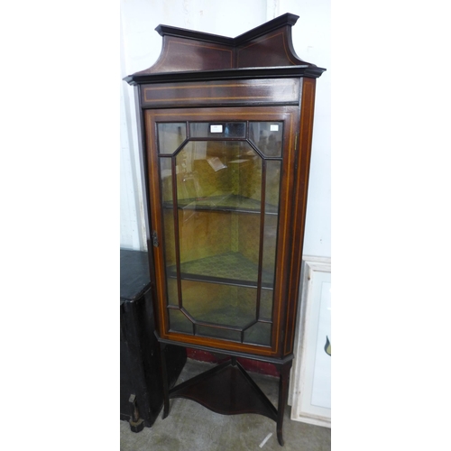 100 - An Edward VII inlaid mahogany corner cabinet on stand