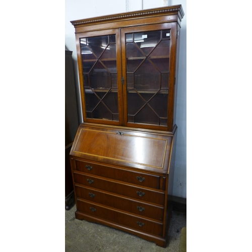 102 - An Edward VII style inlaid mahogany bureau bookcase