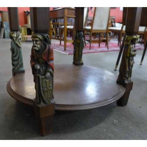 105 - A French oak and glass topped circular two tier coffee table