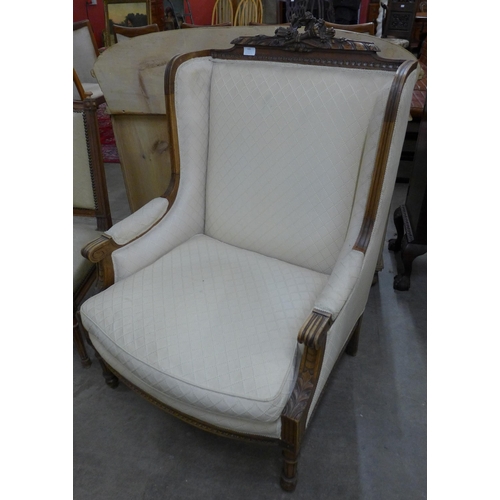 109 - An early 20th Century French carved walnut and fabric upholstered fauteuil chair