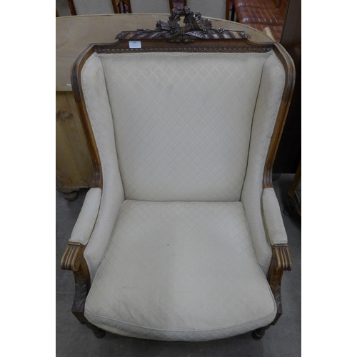 109 - An early 20th Century French carved walnut and fabric upholstered fauteuil chair