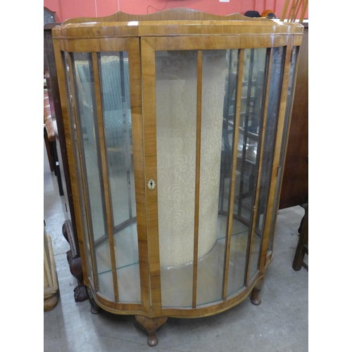 111 - An Art Deco walnut serpentine single door display cabinet