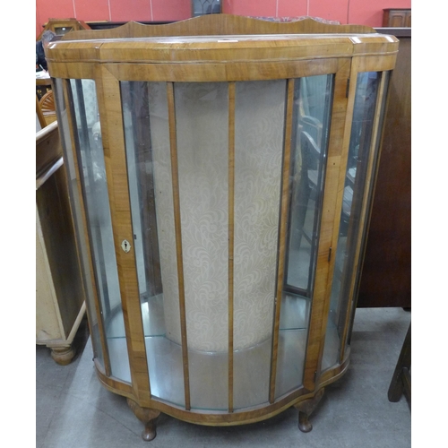 111 - An Art Deco walnut serpentine single door display cabinet