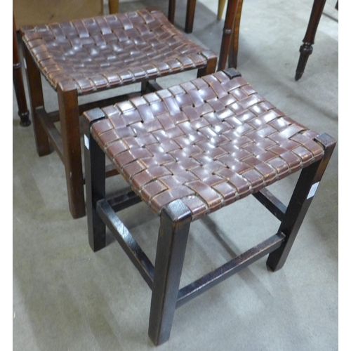 123 - A pair of Arts and Crafts oak and leather strapwork stools