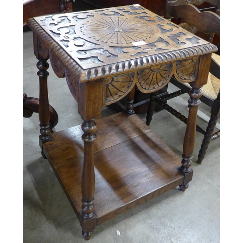 135 - A Victorian Jacobean Revival carved oak occasional table