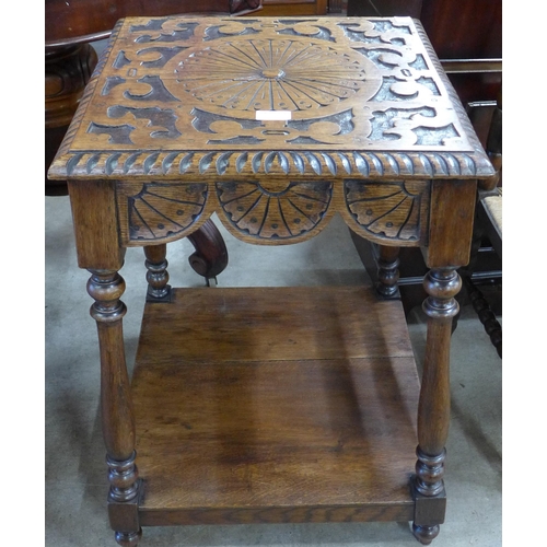 135 - A Victorian Jacobean Revival carved oak occasional table