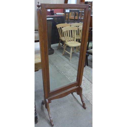 142 - An early 20th Century oak cheval mirror