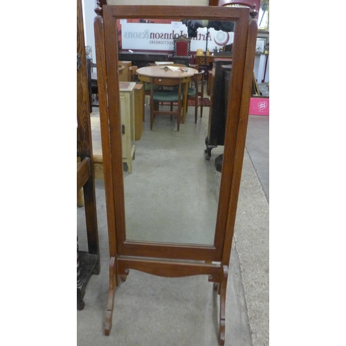 142 - An early 20th Century oak cheval mirror