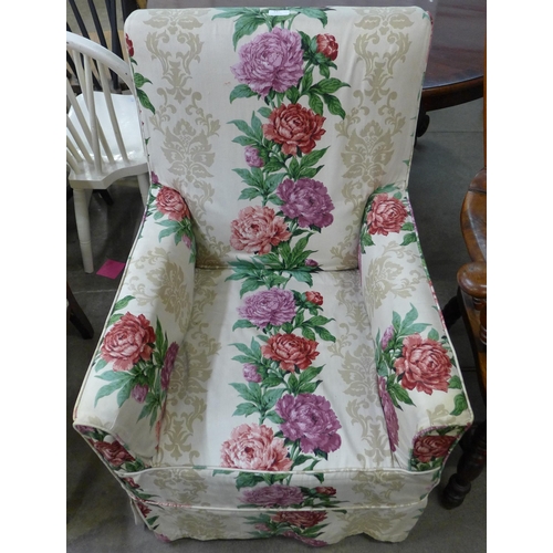 145 - An early 20th Century mahogany and fabric upholstered armchair