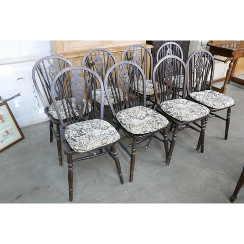 151 - A set of eight elm and beech wheelback kitchen chairs