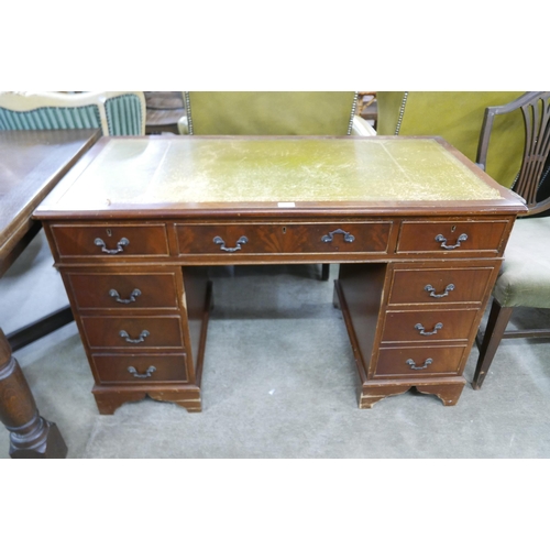 152 - A mahogany and green leather topped pedestal desk