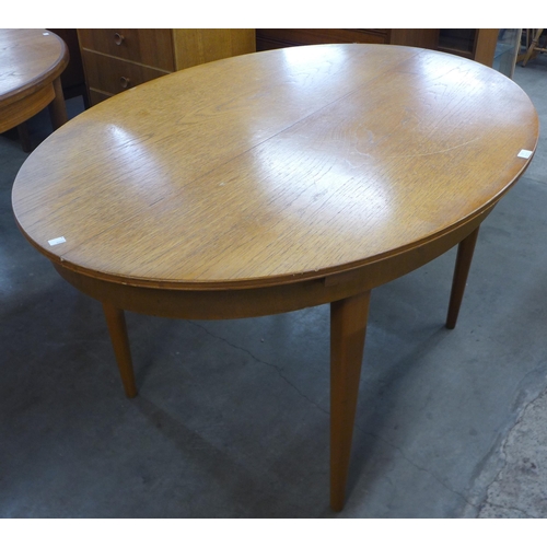 17 - A teak oval extending dining table