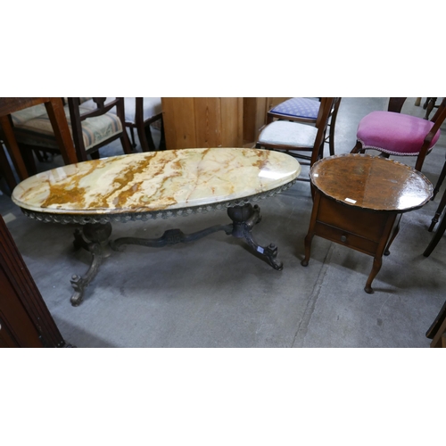 172 - An onyx and brass oval coffee table and a walnut sewing table