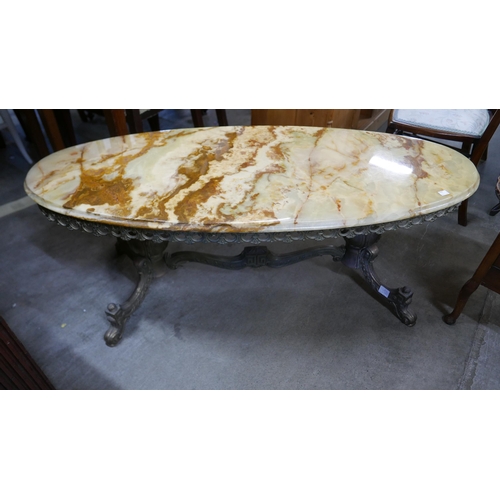 172 - An onyx and brass oval coffee table and a walnut sewing table