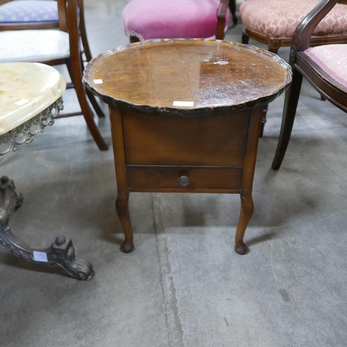 172 - An onyx and brass oval coffee table and a walnut sewing table