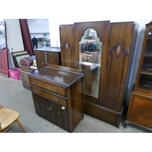 179 - An Art Deco oak five piece bedroom suite, comprising; wardrobe, chest of drawers, two tallboys and a... 