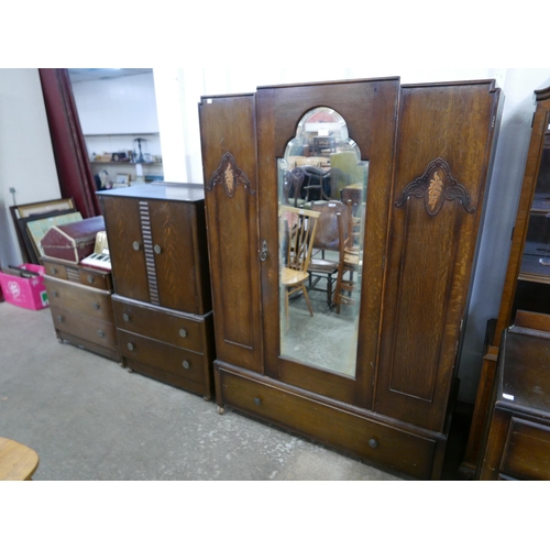 179 - An Art Deco oak five piece bedroom suite, comprising; wardrobe, chest of drawers, two tallboys and a... 