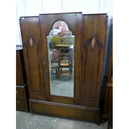 179 - An Art Deco oak five piece bedroom suite, comprising; wardrobe, chest of drawers, two tallboys and a... 