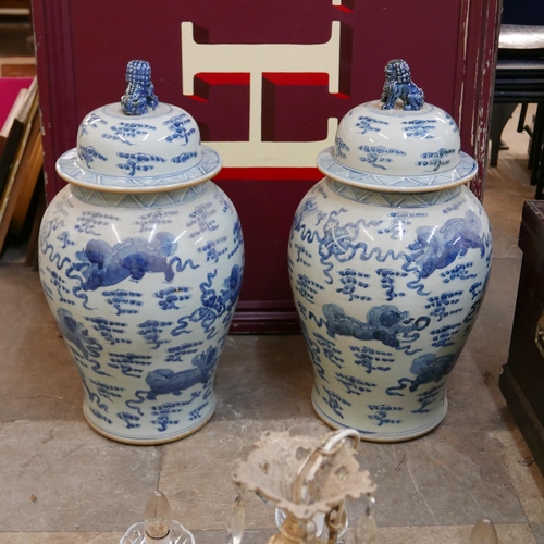 196 - A pair of large Chinese blue and white octagonal stoneware vases and covers