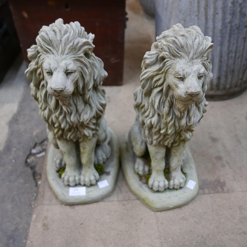 209 - A pair of concrete garden figures of seated lions