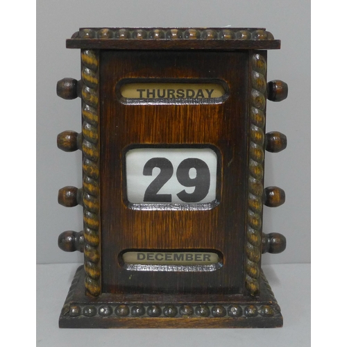 238 - A Victorian oak perpetual desk calendar