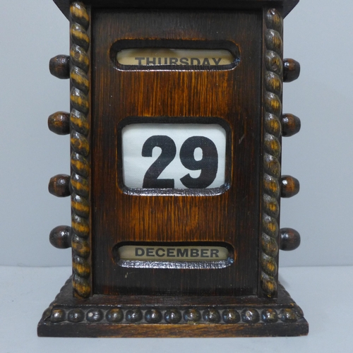 238 - A Victorian oak perpetual desk calendar