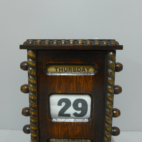 238 - A Victorian oak perpetual desk calendar