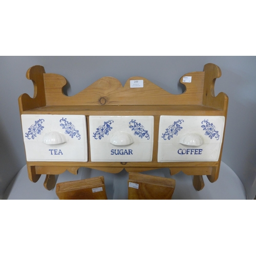 249 - A pine wall hanging tea, coffee and sugar rack and a pair of carved wooden elephant book ends