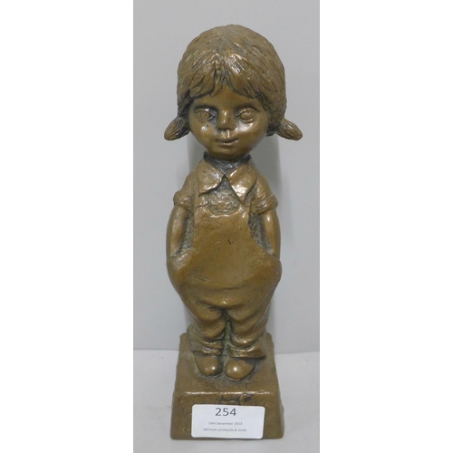 254 - A faux bronze figure of a young girl