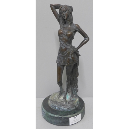 255 - A bronze figure of a lady on, a green marble socle