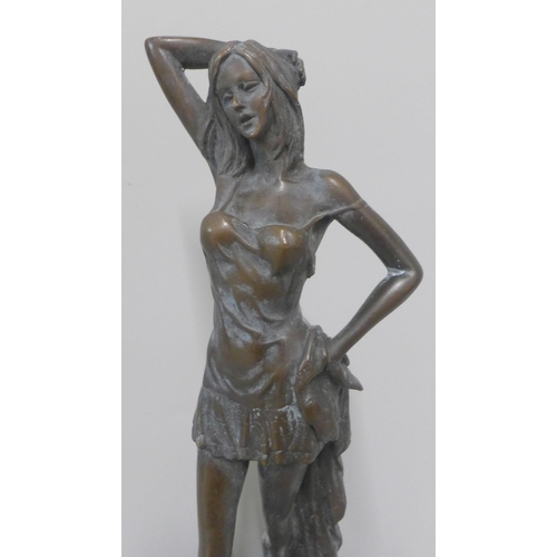 255 - A bronze figure of a lady on, a green marble socle