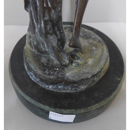 255 - A bronze figure of a lady on, a green marble socle