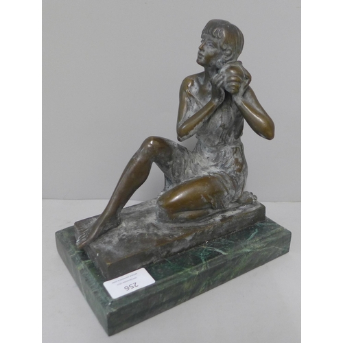 256 - A bronze figure of a lady, on green marble socle