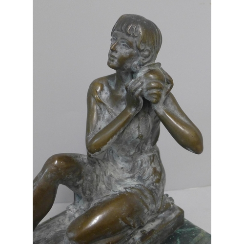 256 - A bronze figure of a lady, on green marble socle