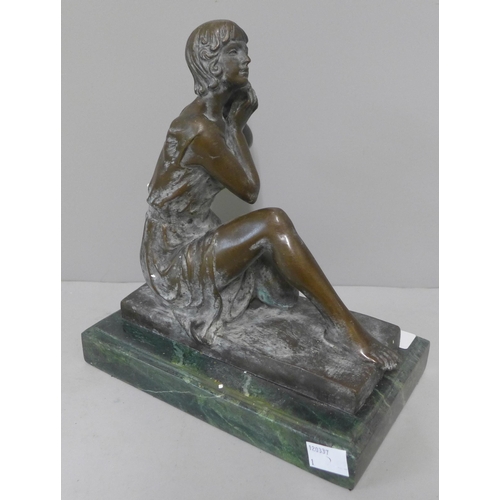 256 - A bronze figure of a lady, on green marble socle