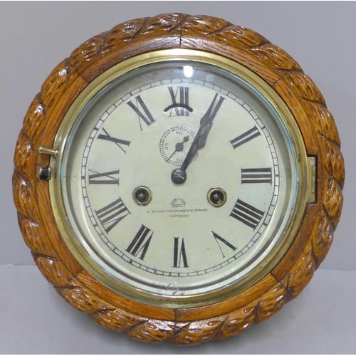 283 - An early 20th Century Dent carved oak circular wall clock