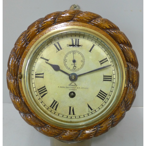 284 - An early 20th Century Dent carved oak circular wall clock