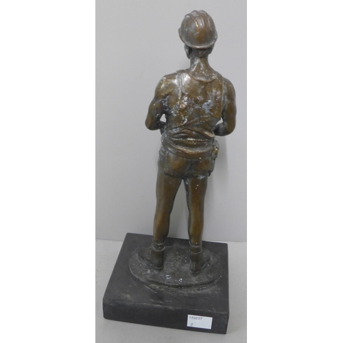 285 - A bronze figure of a miner, on black marble socle