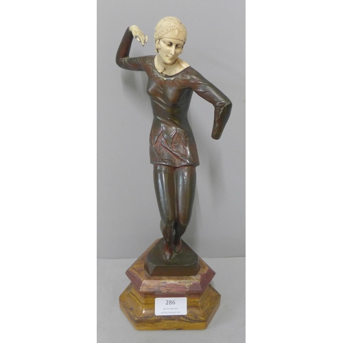 286 - An Art Deco style cast metal and faux ivory figure of a female dancer, a/f