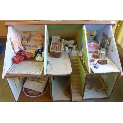 294 - A doll's house, containing furniture and miniature dolls