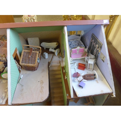 294 - A doll's house, containing furniture and miniature dolls