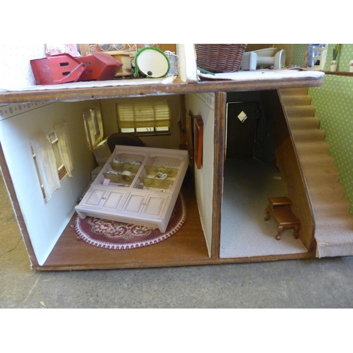 294 - A doll's house, containing furniture and miniature dolls