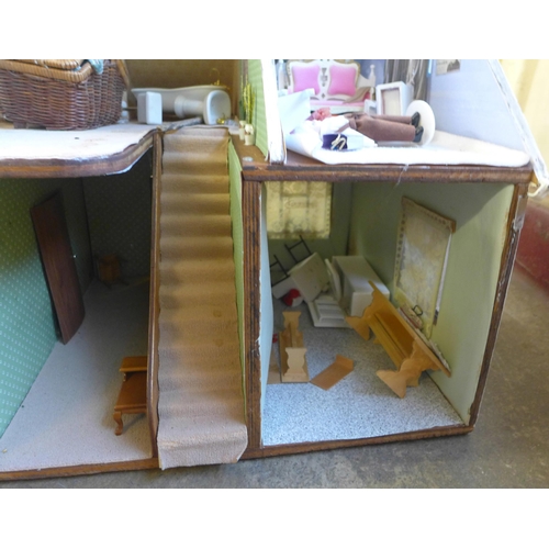 294 - A doll's house, containing furniture and miniature dolls